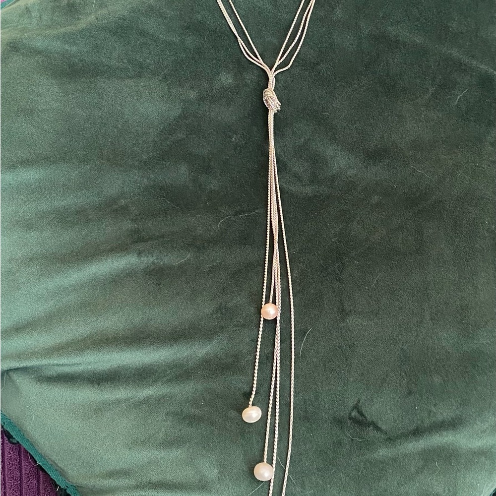 Silver tone knotted chains with pearl dangles.